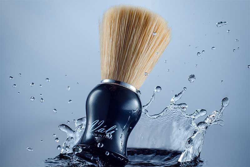 vali shaving brush on blue water splash background